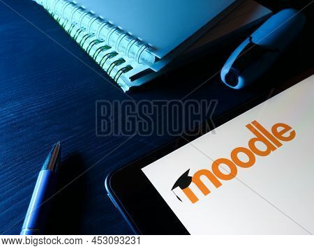Kyiv, Ukraine - March 30, 2022. Tablet With Moodle Logo And Notebooks.