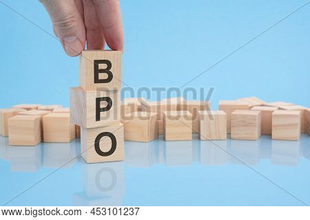 Hand Holding Wood Cube Block With Bpo Text. Financial And Business Concept