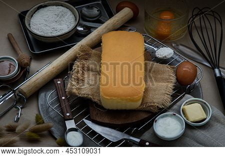 Homemade Butter Cake Or Pound Cake With Ingredients (eggs, Flour, Milk, Butter With Honey) And Rolli