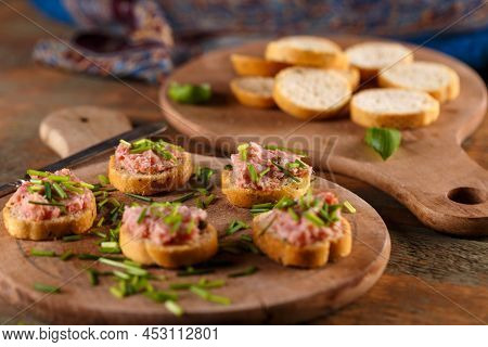 German Teewurst On A Slice Of Bruschetta With Chopped Fresh Chives