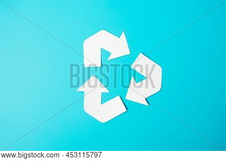 Paper Recycle Logo Cutout On Blue Background. Environmental Protection, Zero Waste, Reusable, Say No