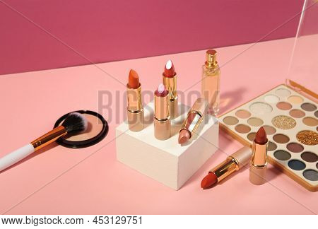 Make Up Products Prsented On White Podium On Pink Pastel Background. Top View