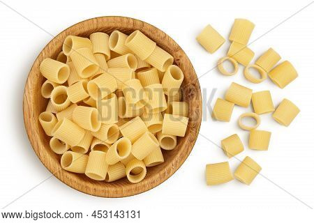 Raw Italian Pasta In Wooden Bowl Isolated On White Background With Clipping Path . Mezze Maniche Rig