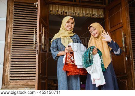 Asian Muslim With Hijab Standing In Front Of The House
