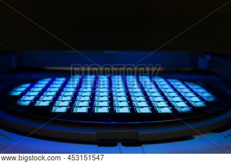 Silicon Wafer With Chips In Uv Lighting. Neon. Ultraviolet Lithography.