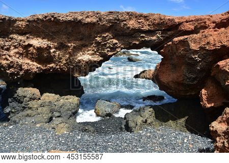 Stunning Lava Rock Natural Bridge On The Coast Of Aruba.