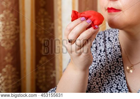 A Jewish Woman Sniffs Bsamim Spices After Shabbat While Holding A Siddur. Horizontal Photo