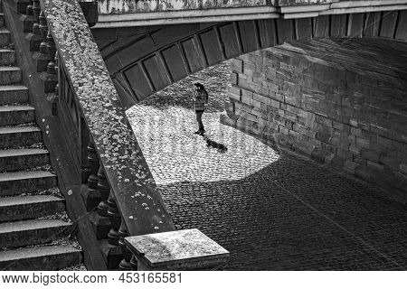 Frankfurt, Germany - April 10, 2022: Man Under The Bridge Playing Saxophone And Enjoys The Acustic O