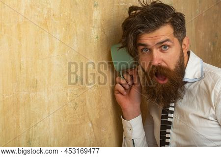 Man Listening Through The Wall With The Cup. Secrets And Gossip Concept. Neighbour And Secret. Funny