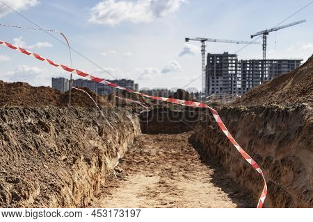 Dig A Trench. Earthworks, Digging Trench. Long Earthen Trench Dug To Lay Pipe Or Optical Fiber. Cons