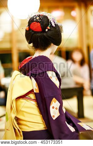 Maiko Apprentice Showing Japanese Traditional Dance. Maiko Is An Apprentice Geisha. Maikos Performin