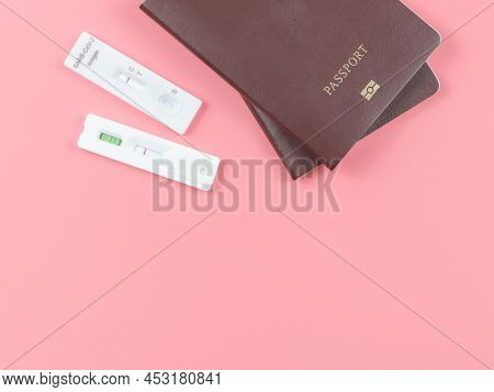 Top View Or Flat Lay Of Two Covid-19 Negative Test Result Antigen Test Kits (atk) And Two  Passport 