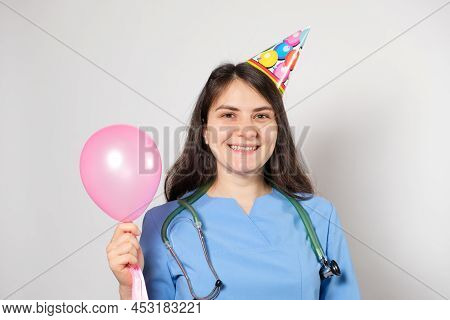 The Doctor Holds A Festive Balloon And Smiles, Happy Doctors Day