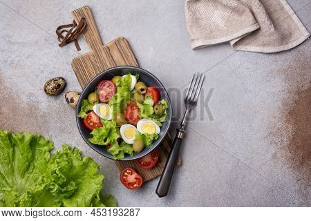 Healthy Salad With Fresh Lettuce, Cherry Tomatoes, Quail Egg And Olives