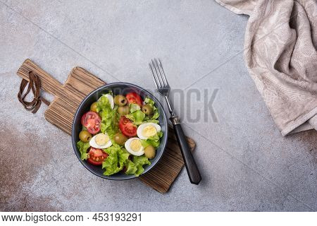 Healthy Salad With Fresh Lettuce, Cherry Tomatoes, Quail Egg And Olives