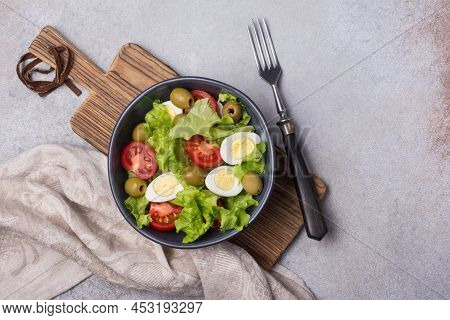 Healthy Salad With Fresh Lettuce, Cherry Tomatoes, Quail Egg And Olives