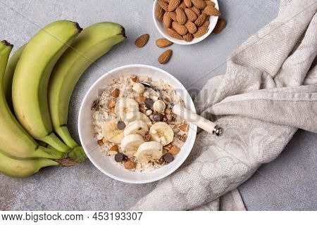 Healthy Breakfast With Oatmeal, Nuts, Banana And Chocolate Drops