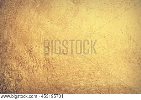 Old Gold Metal Wall Background Or Texture And Shadow.