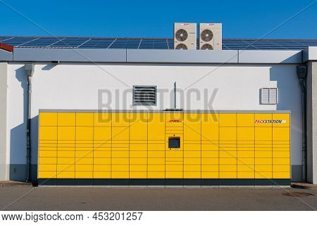 Dhl Yellow Packstation On The White Wall. Paderborn, Germany, March 23, 2022.