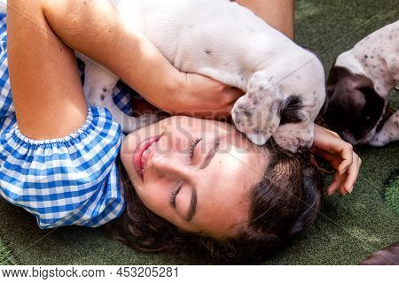 Beautiful Young Girl Having Fun With Her Small French Braque Puppies