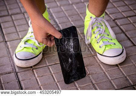 Smartphone Device With Broken Screen Being Picked Up From Floor By Clumsy Young Man, Cell Phone Film