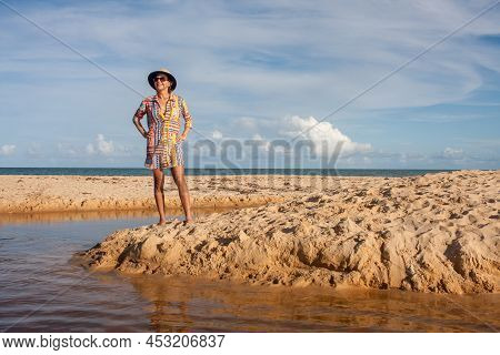 Woman Wearing Colorful Beachwear At The Beach Known As Pitinga, In Arraial D Ajuda, Bahia, Brazil