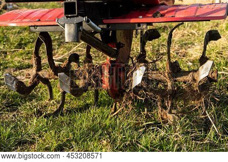 Dirty Cultivator Blades Close-up. Tilling The Land On The Farm. Farming.