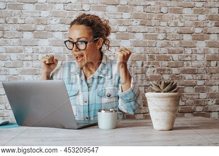 Happy Woman Exult And Celebrate In Front Of A Laptop After Receiving A Notification Or Email Message