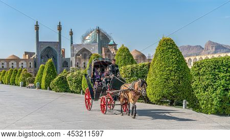 Isfahan, Iran - May 2019: Tourists Having A Horse Carriage Ride Around Isfahan Naqsh-e Jahan Square 