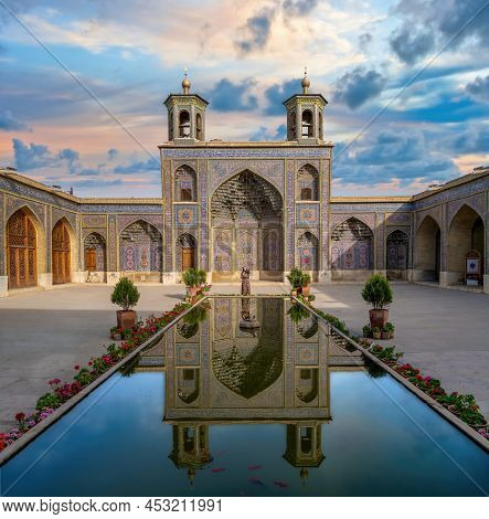 Shiraz, Iran - May 2019: Iranian Woman Standing By The Pool Of Nasir Al-mulk Mosque During Sunset. N
