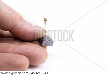 Carbon Brushes In Hand Isolated On A White Background. Brushes For Electric Motor.spare Parts For An