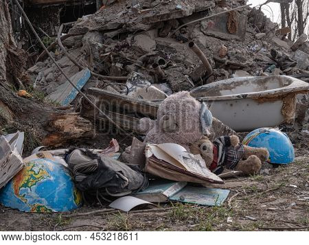 Borodyanka, Ukraine - April 2022: Childrens Dirty Toys Near The House After An Airstrike By Russian 