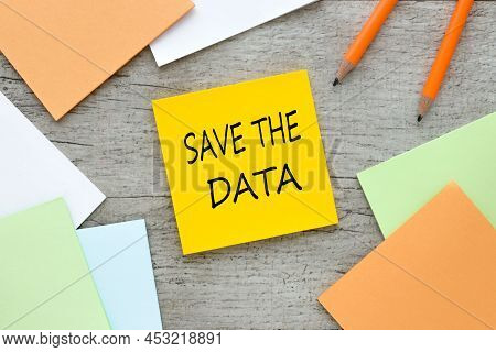 Save The Date. Text On Orange Sticky Note On Wooden Background