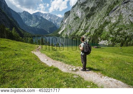 Man With Backpack On Summer Hike Around Hinterer Gosausee, Salzkammergut. Austria