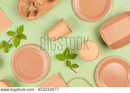 Flat Lay Composition With Eco-friendly Tableware And Kraft Paper Food Packaging On Light Green Backg