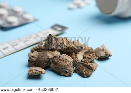 Pile Of Kidney Stones On Light Blue Background, Closeup