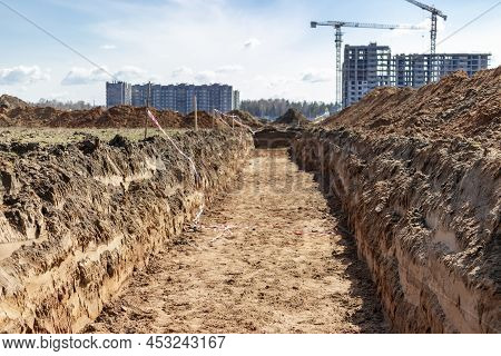 Dig A Trench. Earthworks, Digging Trench. Long Earthen Trench Dug To Lay Pipe Or Optical Fiber. Cons