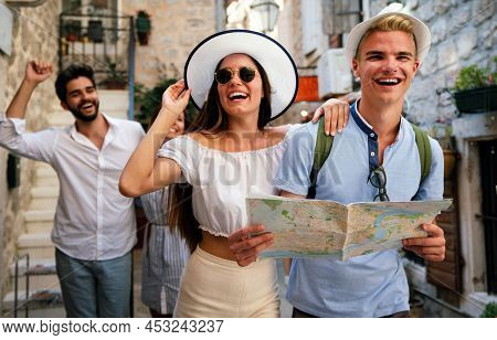 Smiling Gorup Of Friends With Map. Tourism, Travel, Leisure, Holidays And Friendship Concept