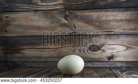 Araucana Egg On Wooden Background. Light Blue Egg From Araucana Chicken. Easter Festival Concepts. E