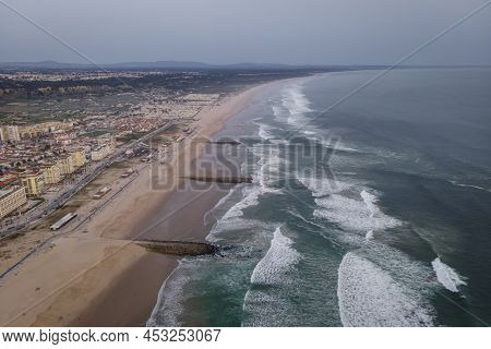 Aerial View Of Costa Da Caparica Landscape At Sunset, View Of The Majestic Beach With Rough Atlantic