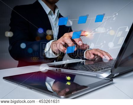The Businessman Is Using A Laptop Computer. To Properly Handle Files, Knowledge, And Documentation I