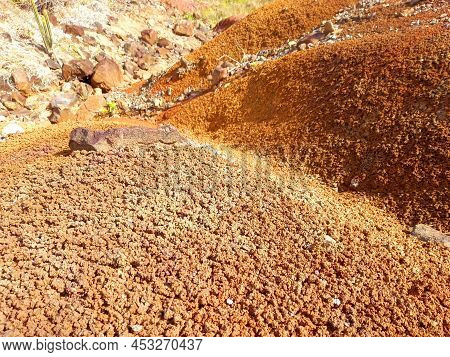 Background Of Ocher-colored Volcanic Rocks Of Different Shapes And Sizes In A Natural Environment. F