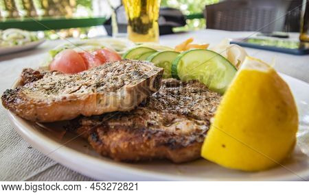 Grilled Piglet Meat Served With Vegetable (the Albanian Meze Or Garniture Dish).