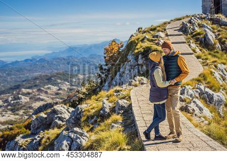 Couple Man And Woman Tourists In Mountain Landscape At National Park Lovcen, Montenegro. Travel To M