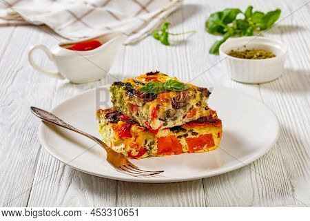 A Portion Of Baked In Oven Vegetable Casserole Of Beaten Eggs, Red Onion, Sweet Potato, Broccoli, Re