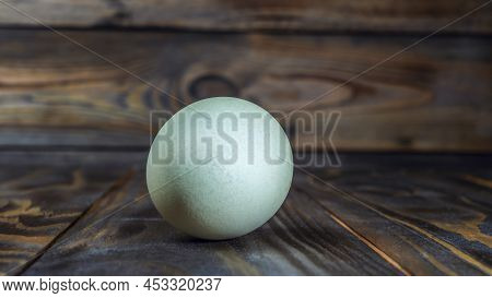Araucana Egg On Wooden Background. Light Blue Egg From Araucana Chicken. Easter Festival Concepts. E