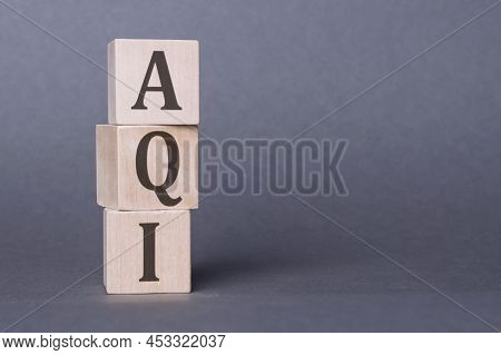 Aqi Abbreviation Of Air Quality Index Text On Wooden Cubes On Dark Gray Wall Background.