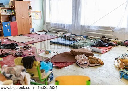 Barmashovo, Ukraine- March 18, 2022: Dirt And Trash, Garbage With Mat In Half-destroyed School Room 