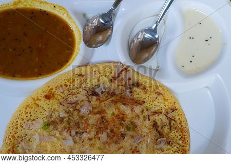Uttapam Is Served With Chutney On White Plate, Indian Vegetable Dish.