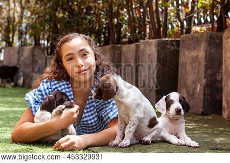 Beautiful Young Girl Having Fun With Her Small French Braque Puppies